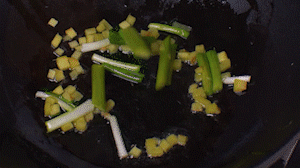 鍋中熱油，依次下姜粒、蔥段、蘆筍炒香。