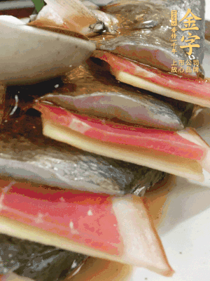 魚肚中塞蔥結(jié)、火腿片，魚身上碼放姜片、火腿片，倒入混合的料汁。